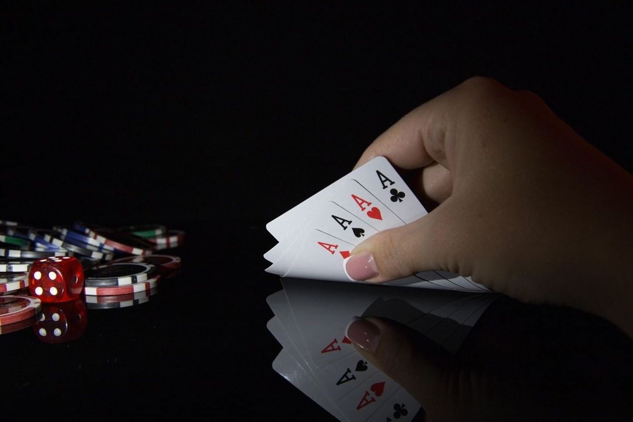 Player holding four aces at a private game