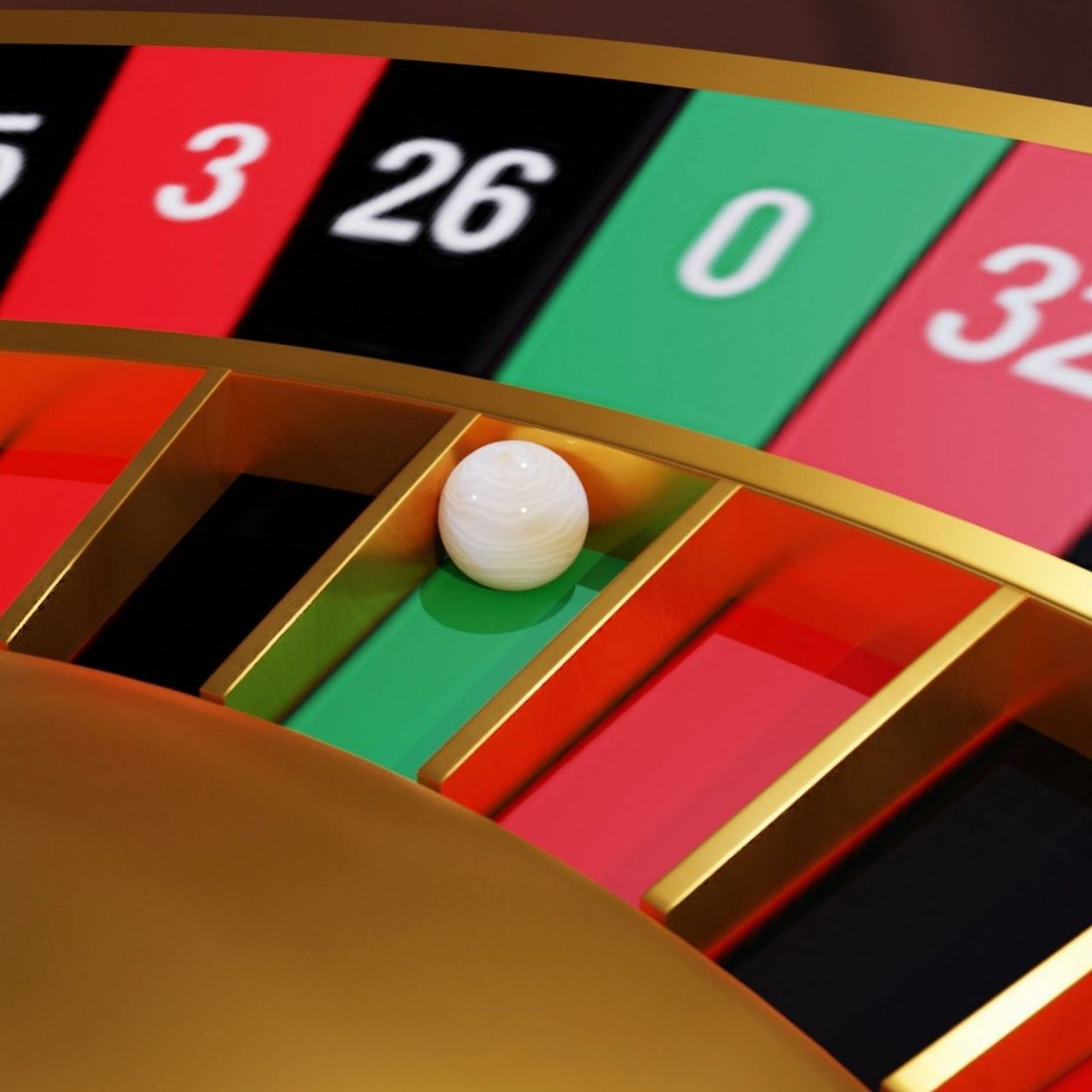 Roulette wheel with ball on zero
